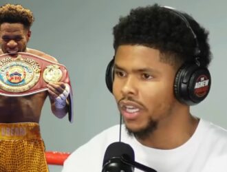 Devin Haney with the WBO belt beside a podcast host discussing the stalled Shakur Stevenson catchweight fight